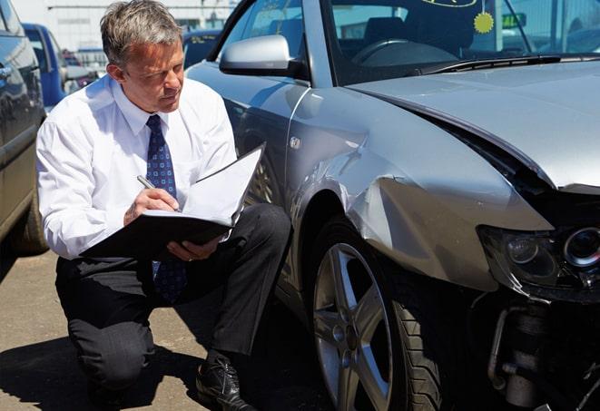 gray car parked with insurance coverage displayed